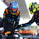 SUZUKA, JAPAN - SEPTEMBER 23:  Second placed qualifier Oscar Piastri of Australia and McLaren is congratulated by Third placed qualifier Lando Norris of Great Britain and McLaren as he climbs out of his car in parc ferme during qualifying ahead of the F1 Grand Prix of Japan at Suzuka International Racing Course on September 23, 2023 in Suzuka, Japan. (Photo by Dan Istitene - Formula 1/Formula 1 via Getty Images)