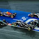 LAS VEGAS, NEVADA - NOVEMBER 18: Fernando Alonso of Spain driving the (14) Aston Martin AMR23 Mercedes and Valtteri Bottas of Finland driving the (77) Alfa Romeo F1 C43 Ferrari collide at turn one during the F1 Grand Prix of Las Vegas at Las Vegas Strip Circuit on November 18, 2023 in Las Vegas, Nevada. (Photo by Chris Graythen/Getty Images)