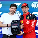 MEXICO CITY, MEXICO - OCTOBER 28: Pole position qualifier Charles Leclerc of Monaco and Ferrari is presented with the Pirelli Pole Position Award. by Jimmy Alvarez in parc ferme during qualifying ahead of the F1 Grand Prix of Mexico at Autodromo Hermanos Rodriguez on October 28, 2023 in Mexico City, Mexico. (Photo by Mark Thompson/Getty Images)