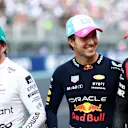 MIAMI, FLORIDA - MAY 06: Pole position qualifier Sergio Perez of Mexico and Oracle Red Bull Racing (C), Second placed qualifier Fernando Alonso of Spain and Aston Martin F1 Team (L) and Third placed qualifier Carlos Sainz of Spain and Ferrari (R) talk in parc ferme during qualifying ahead of the F1 Grand Prix of Miami at Miami International Autodrome on May 06, 2023 in Miami, Florida. (Photo by Dan Istitene - Formula 1/Formula 1 via Getty Images)
