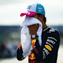 MIAMI, FLORIDA - MAY 06: Pole position qualifier Sergio Perez of Mexico and Oracle Red Bull Racing wipes his face with a towel in parc ferme during qualifying ahead of the F1 Grand Prix of Miami at Miami International Autodrome on May 06, 2023 in Miami, Florida. (Photo by Mario Renzi - Formula 1/Formula 1 via Getty Images)