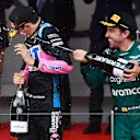 MONTE-CARLO, MONACO - MAY 28: Second placed Fernando Alonso of Spain and Aston Martin F1 Team and Third placed Esteban Ocon of France and Alpine F1 celebrate on the podium during the F1 Grand Prix of Monaco at Circuit de Monaco on May 28, 2023 in Monte-Carlo, Monaco. (Photo by Rudy Carezzevoli - Formula 1/Formula 1 via Getty Images)