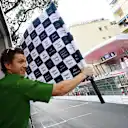 Holland waves the checkered flag at the Monaco Grand Prix in 2023