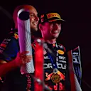 LUSAIL CITY, QATAR - OCTOBER 08: Race winner Max Verstappen of the Netherlands and Oracle Red Bull Racing and race engineer Gianpiero Lambiase celebrate on the podium during the F1 Grand Prix of Qatar at Lusail International Circuit on October 08, 2023 in Lusail City, Qatar. (Photo by Rudy Carezzevoli/Getty Images)