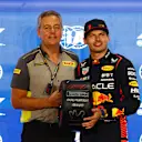 LUSAIL CITY, QATAR - OCTOBER 06: Pole position qualifier Max Verstappen of the Netherlands and Oracle Red Bull Racing is presented with the Pirelli Pole Position Trophy by Director of Pirelli F1 Mario Isola during qualifying ahead of the F1 Grand Prix of Qatar at Lusail International Circuit on October 06, 2023 in Lusail City, Qatar. (Photo by Mark Thompson/Getty Images)