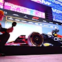 LUSAIL CITY, QATAR - OCTOBER 07: Third placed Lando Norris of Great Britain and McLaren looks at the car of Max Verstappen of the Netherlands and Oracle Red Bull Racing (not pictured) in parc ferme during the Sprint ahead of the F1 Grand Prix of Qatar at Lusail International Circuit on October 07, 2023 in Lusail City, Qatar. (Photo by Dan Istitene - Formula 1/Formula 1 via Getty Images)