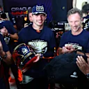 LUSAIL CITY, QATAR - OCTOBER 07: 2023 F1 World Drivers Champion Max Verstappen of the Netherlands and Oracle Red Bull Racing is congratulted by Red Bull Racing Team Principal Christian Horner , Chalerm Yoovidhya and Red Bull Racing Team Consultant Dr Helmut Marko as he is presented with a celebratory helmet after the sprint race ahead of the F1 Grand Prix of Qatar at Lusail International Circuit on October 07, 2023 in Lusail City, Qatar. (Photo by Dan Istitene - Formula 1/Formula 1 via Getty Images)