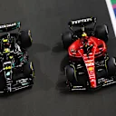 JEDDAH, SAUDI ARABIA - MARCH 19: Carlos Sainz of Spain driving (55) the Ferrari SF-23 and Lewis Hamilton of Great Britain driving the (44) Mercedes AMG Petronas F1 Team W14 battle for track position during the F1 Grand Prix of Saudi Arabia at Jeddah Corniche Circuit on March 19, 2023 in Jeddah, Saudi Arabia. (Photo by Lars Baron/Getty Images)