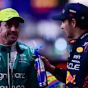 JEDDAH, SAUDI ARABIA - MARCH 18: Pole position qualifier Sergio Perez of Mexico and Oracle Red Bull Racing and and Third placed qualifier Fernando Alonso of Spain and Aston Martin F1 Team talk in parc ferme during qualifying ahead of the F1 Grand Prix of Saudi Arabia at Jeddah Corniche Circuit on March 18, 2023 in Jeddah, Saudi Arabia. (Photo by Mario Renzi - Formula 1/Formula 1 via Getty Images)