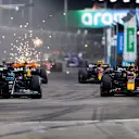 SINGAPORE, SINGAPORE - SEPTEMBER 17: George Russell of Great Britain driving the (63) Mercedes AMG Petronas F1 Team W14 and Max Verstappen of the Netherlands driving the (1) Oracle Red Bull Racing RB19 compete for position on track during the F1 Grand Prix of Singapore at Marina Bay Street Circuit on September 17, 2023 in Singapore, Singapore. (Photo by Clive Rose/Getty Images)