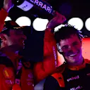 SINGAPORE, SINGAPORE - SEPTEMBER 17: Race winner Carlos Sainz of Spain and Ferrari celebrates with Second placed Lando Norris of Great Britain and McLaren on the podium during the F1 Grand Prix of Singapore at Marina Bay Street Circuit on September 17, 2023 in Singapore, Singapore. (Photo by Mario Renzi - Formula 1/Formula 1 via Getty Images)