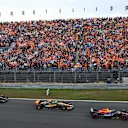 ZANDVOORT, NETHERLANDS - AUGUST 27: Max Verstappen of the Netherlands driving the (1) Oracle Red Bull Racing RB19 leads Lando Norris of Great Britain driving the (4) McLaren MCL60 Mercedes and George Russell of Great Britain driving the (63) Mercedes AMG Petronas F1 Team W14 into turn one at the start during the F1 Grand Prix of The Netherlands at Circuit Zandvoort on August 27, 2023 in Zandvoort, Netherlands. (Photo by Dan Istitene - Formula 1/Formula 1 via Getty Images)
