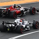 ZANDVOORT, NETHERLANDS - AUGUST 27: Liam Lawson of New Zealand driving the (40) Scuderia AlphaTauri AT04 and Zhou Guanyu of China driving the (24) Alfa Romeo F1 C43 Ferrari battle for track position during the F1 Grand Prix of The Netherlands at Circuit Zandvoort on August 27, 2023 in Zandvoort, Netherlands. (Photo by Mark Thompson/Getty Images)
