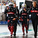 ZANDVOORT, NETHERLANDS - AUGUST 26: 16th placed qualifier Zhou Guanyu of China and Alfa Romeo F1 and 19th placed qualifier Valtteri Bottas of Finland and Alfa Romeo F1 walk in the Pitlane during qualifying ahead of the F1 Grand Prix of The Netherlands at Circuit Zandvoort on August 26, 2023 in Zandvoort, Netherlands. (Photo by Mark Thompson/Getty Images)