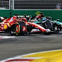 SINGAPORE, SINGAPORE - SEPTEMBER 22: Charles Leclerc of Monaco driving the (16) Ferrari SF-24 and George Russell of Great Britain driving the (63) Mercedes AMG Petronas F1 Team W15 battle for position during the F1 Grand Prix of Singapore at Marina Bay Street Circuit on September 22, 2024 in Singapore, Singapore. (Photo by Clive Rose - Formula 1/Formula 1 via Getty Images)