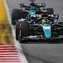 SINGAPORE, SINGAPORE - SEPTEMBER 22: Lewis Hamilton of Great Britain driving the (44) Mercedes AMG Petronas F1 Team W15 leads George Russell of Great Britain driving the (63) Mercedes AMG Petronas F1 Team W15 on track during the F1 Grand Prix of Singapore at Marina Bay Street Circuit on September 22, 2024 in Singapore, Singapore. (Photo by Rudy Carezzevoli/Getty Images)