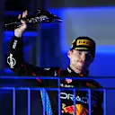 SINGAPORE, SINGAPORE - SEPTEMBER 22: Second placed Max Verstappen of the Netherlands and Oracle Red Bull Racing celebrates on the podium during the F1 Grand Prix of Singapore at Marina Bay Street Circuit on September 22, 2024 in Singapore, Singapore. (Photo by Clive Mason/Getty Images)
