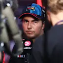 SINGAPORE, SINGAPORE - SEPTEMBER 21: 13th placed qualifier Sergio Perez of Mexico and Oracle Red Bull Racing talks to the media in the Paddock during qualifying ahead of the F1 Grand Prix of Singapore at Marina Bay Street Circuit on September 21, 2024 in Singapore, Singapore. (Photo by Lars Baron - Formula 1/Formula 1 via Getty Images)