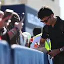 ABU DHABI, UNITED ARAB EMIRATES - DECEMBER 08: Alexander Albon of Thailand and Williams signs autographs for fans in the Paddock prior to the F1 Grand Prix of Abu Dhabi at Yas Marina Circuit on December 08, 2024 in Abu Dhabi, United Arab Emirates. (Photo by Rudy Carezzevoli/Getty Images)