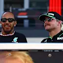 ABU DHABI, UNITED ARAB EMIRATES - DECEMBER 08: Lewis Hamilton of Great Britain and Mercedes and Valtteri Bottas of Finland and Stake F1 Team Kick Sauber talk on the drivers parade prior to the F1 Grand Prix of Abu Dhabi at Yas Marina Circuit on December 08, 2024 in Abu Dhabi, United Arab Emirates. (Photo by Mark Thompson/Getty Images)