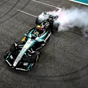 ABU DHABI, UNITED ARAB EMIRATES - DECEMBER 08: 4th placed Lewis Hamilton of Great Britain driving the (44) Mercedes AMG Petronas F1 Team W15 does donuts on track to celebrate his final race with Mercedes during the F1 Grand Prix of Abu Dhabi at Yas Marina Circuit on December 08, 2024 in Abu Dhabi, United Arab Emirates. (Photo by Clive Mason/Getty Images)