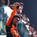 ABU DHABI, UNITED ARAB EMIRATES - DECEMBER 08: Race winner Lando Norris of Great Britain and McLaren celebrates on the podium during the F1 Grand Prix of Abu Dhabi at Yas Marina Circuit on December 08, 2024 in Abu Dhabi, United Arab Emirates. (Photo by Mark Thompson/Getty Images)