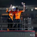 ABU DHABI, UNITED ARAB EMIRATES - DECEMBER 08: Race winner Lando Norris of Great Britain and McLaren and McLaren Chief Executive Officer Zak Brown celebrate on the podium after the McLaren team won the 2024 F1 Constructors Championship during the F1 Grand Prix of Abu Dhabi at Yas Marina Circuit on December 08, 2024 in Abu Dhabi, United Arab Emirates. (Photo by Peter Fox - Formula 1/Formula 1 via Getty Images)
