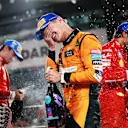 ABU DHABI, UNITED ARAB EMIRATES - DECEMBER 08: Race winner Lando Norris of Great Britain and McLaren celebrates on the podium during the F1 Grand Prix of Abu Dhabi at Yas Marina Circuit on December 08, 2024 in Abu Dhabi, United Arab Emirates. (Photo by Bryn Lennon - Formula 1/Formula 1 via Getty Images)