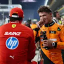 ABU DHABI, UNITED ARAB EMIRATES - DECEMBER 07: Pole position qualifier Lando Norris of Great Britain and McLaren and Third placed qualifier Carlos Sainz of Spain and Ferrari talk in parc ferme during qualifying ahead of the F1 Grand Prix of Abu Dhabi at Yas Marina Circuit on December 07, 2024 in Abu Dhabi, United Arab Emirates. (Photo by Bryn Lennon - Formula 1/Formula 1 via Getty Images)