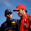 MELBOURNE, AUSTRALIA - MARCH 23: Second placed qualifier Carlos Sainz of Spain and Ferrari and Pole position qualifier Max Verstappen of the Netherlands and Oracle Red Bull Racing talk in parc ferme during qualifying ahead of the F1 Grand Prix of Australia at Albert Park Circuit on March 23, 2024 in Melbourne, Australia. (Photo by Clive Mason - Formula 1/Formula 1 via Getty Images)