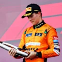 BAKU, AZERBAIJAN - SEPTEMBER 15: Race winner Oscar Piastri of Australia and McLaren celebrates on the podium during the F1 Grand Prix of Azerbaijan at Baku City Circuit on September 15, 2024 in Baku, Azerbaijan. (Photo by Joe Portlock - Formula 1/Formula 1 via Getty Images)
