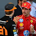 BAKU, AZERBAIJAN - SEPTEMBER 15: Race winner Oscar Piastri of Australia and McLaren and Second placed Charles Leclerc of Monaco and Ferrari talk in parc ferme during the F1 Grand Prix of Azerbaijan at Baku City Circuit on September 15, 2024 in Baku, Azerbaijan. (Photo by James Sutton/Getty Images)
