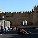 Drivers thread the needle through the narrow turn past a section of UNESCO World Heritage castle.