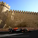 A postcard scene: Formula 1 cars rush past the 12th-century Icherisheher.