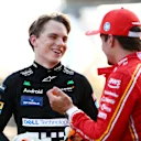 BAKU, AZERBAIJAN - SEPTEMBER 14: Pole position qualifier Charles Leclerc of Monaco and Ferrari talks with Second placed qualifier Oscar Piastri of Australia and McLaren in parc ferme during qualifying ahead of the F1 Grand Prix of Azerbaijan at Baku City Circuit on September 14, 2024 in Baku, Azerbaijan. (Photo by Clive Rose - Formula 1/Formula 1 via Getty Images)
