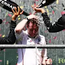 SPA, BELGIUM - JULY 28: Race winner George Russell of Great Britain and Mercedes (R), Second placed Lewis Hamilton of Great Britain and Mercedes (L) and Lead Race Stragegist of Mercedes (C) celebrate on the podium during the F1 Grand Prix of Belgium at Circuit de Spa-Francorchamps on July 28, 2024 in Spa, Belgium. (Photo by Peter Fox - Formula 1/Formula 1 via Getty Images)