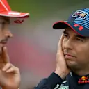 SPA, BELGIUM - JULY 27: Third placed qualifier Sergio Perez of Mexico and Oracle Red Bull Racing and Second placed qualifier Charles Leclerc of Monaco and Ferrari talk in parc ferme during qualifying ahead of the F1 Grand Prix of Belgium at Circuit de Spa-Francorchamps on July 27, 2024 in Spa, Belgium. (Photo by Rudy Carezzevoli/Getty Images)