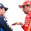 SPA, BELGIUM - JULY 27: Third placed qualifier Sergio Perez of Mexico and Oracle Red Bull Racing and Second placed qualifier Charles Leclerc of Monaco and Ferrari talk in parc ferme during qualifying ahead of the F1 Grand Prix of Belgium at Circuit de Spa-Francorchamps on July 27, 2024 in Spa, Belgium. (Photo by Bryn Lennon - Formula 1/Formula 1 via Getty Images)
