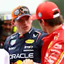 SPA, BELGIUM - JULY 27: Pole position qualifier Max Verstappen of the Netherlands and Oracle Red Bull Racing talks with Second placed qualifier Charles Leclerc of Monaco and Ferrari in parc ferme during qualifying ahead of the F1 Grand Prix of Belgium at Circuit de Spa-Francorchamps on July 27, 2024 in Spa, Belgium. (Photo by Bryn Lennon - Formula 1/Formula 1 via Getty Images)