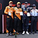 SAO PAULO, BRAZIL - NOVEMBER 02: Sprint winner Lando Norris of Great Britain and McLaren, Second placed Oscar Piastri of Australia and McLaren, Third placed Max Verstappen of the Netherlands and Oracle Red Bull Racing and Emerson Fittipaldi pose for a photo in parc ferme during the Sprint ahead of the F1 Grand Prix of Brazil at Autodromo Jose Carlos Pace on November 02, 2024 in Sao Paulo, Brazil. (Photo by Lars Baron - Formula 1/Formula 1 via Getty Images)