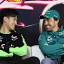 SHANGHAI, CHINA - APRIL 18: Zhou Guanyu of China and Stake F1 Team Kick Sauber and Fernando Alonso of Spain and Aston Martin F1 Team talk in the Drivers Press Conference during previews ahead of the F1 Grand Prix of China at Shanghai International Circuit on April 18, 2024 in Shanghai, China. (Photo by Lintao Zhang/Getty Images )