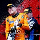 IMOLA, ITALY - MAY 19: Second placed Lando Norris of Great Britain and McLaren celebrates on the podium during the F1 Grand Prix of Emilia-Romagna at Autodromo Enzo e Dino Ferrari Circuit on May 19, 2024 in Imola, Italy. (Photo by Clive Rose/Getty Images)