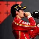 IMOLA, ITALY - MAY 19: Third placed Charles Leclerc of Monaco and Ferrari celebrates on the podium during the F1 Grand Prix of Emilia-Romagna at Autodromo Enzo e Dino Ferrari Circuit on May 19, 2024 in Imola, Italy. (Photo by Bryn Lennon - Formula 1/Formula 1 via Getty Images)