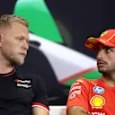 IMOLA, ITALY - MAY 16: Kevin Magnussen of Denmark and Haas F1 and Carlos Sainz of Spain and Ferrari talk in the Drivers Press Conference during previews ahead of the F1 Grand Prix of Emilia-Romagna at Autodromo Enzo e Dino Ferrari Circuit on May 16, 2024 in Imola, Italy. (Photo by Lars Baron/Getty Images)
