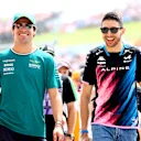 BUDAPEST, HUNGARY - JULY 21: Lance Stroll of Canada and Aston Martin F1 Team and Esteban Ocon of France and Alpine F1 talk on the drivers parade prior to the F1 Grand Prix of Hungary at Hungaroring on July 21, 2024 in Budapest, Hungary. (Photo by Bryn Lennon - Formula 1/Formula 1 via Getty Images)