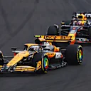 BUDAPEST, HUNGARY - JULY 21: Lando Norris of Great Britain driving the (4) McLaren MCL38 Mercedes leads Max Verstappen of the Netherlands driving the (1) Oracle Red Bull Racing RB20 during the F1 Grand Prix of Hungary at Hungaroring on July 21, 2024 in Budapest, Hungary. (Photo by Mark Thompson/Getty Images)