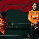 BUDAPEST, HUNGARY - JULY 21:Race winner Oscar Piastri of Australia and McLaren and Second placed Lando Norris of Great Britain and McLaren stand on the podium during the F1 Grand Prix of Hungary at Hungaroring on July 21, 2024 in Budapest, Hungary. (Photo by Joe Portlock - Formula 1/Formula 1 via Getty Images)