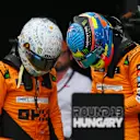 BUDAPEST, HUNGARY - JULY 20: Pole position qualifier Lando Norris of Great Britain and McLaren and Second placed qualifier Oscar Piastri of Australia and McLaren talk in parc ferme during qualifying ahead of the F1 Grand Prix of Hungary at Hungaroring on July 20, 2024 in Budapest, Hungary. (Photo by Rudy Carezzevoli/Getty Images)