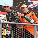MONZA, ITALY - SEPTEMBER 01: Race winner Charles Leclerc of Monaco and Ferrari and Second placed Oscar Piastri of Australia and McLaren celebrates on the podium during the F1 Grand Prix of Italy at Autodromo Nazionale Monza on September 01, 2024 in Monza, Italy. (Photo by James Sutton - Formula 1/Formula 1 via Getty Images)