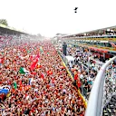 MONZA, ITALY - SEPTEMBER 01: Race winner Charles Leclerc of Monaco and Ferrari waves to fans from the podium during the F1 Grand Prix of Italy at Autodromo Nazionale Monza on September 01, 2024 in Monza, Italy. (Photo by Bryn Lennon - Formula 1/Formula 1 via Getty Images)